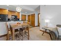 Cozy dining area with a table and chairs, adjacent to kitchen at 34 Highfield Trl # 203, Breckenridge, CO 80424