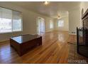 Bright living room featuring hardwood floors and a fireplace at 1453 Chester St, Aurora, CO 80010