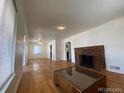 Living room with hardwood floors and a brick fireplace at 1453 Chester St, Aurora, CO 80010