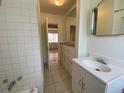Clean bathroom with tiled walls, vanity, and mirrored medicine cabinet at 1453 Chester St, Aurora, CO 80010