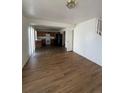 Open concept living room and kitchen with laminate flooring at 4361 Argonne St, Denver, CO 80249