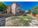 Large backyard with a wooden fence and grassy area at 4952 N Silverlace Dr, Castle Rock, CO 80109