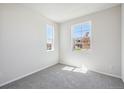 Bright bedroom with neutral carpeting and large windows at 855 Goodrich Peak St, Erie, CO 80516