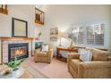 Cozy living room with fireplace and comfortable seating at 11355 W 84Th Pl # D, Arvada, CO 80005