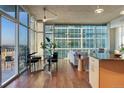 Open concept living area with hardwood floors and city views from large windows at 1700 Bassett St # 1303, Denver, CO 80202