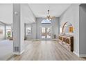 Dining area with wood-look flooring, built-in hutch, and access to the backyard at 1012 E 130Th Pl, Thornton, CO 80241