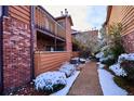 Snow-covered pathway between brick and wood buildings at 2277 S Buckley Rd # 102, Aurora, CO 80013