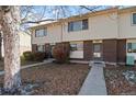 Three-unit townhouse building exterior, showing a well-maintained front yard and walkway at 1290 S Troy St, Aurora, CO 80012