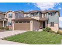 Two-story house with a brown garage door and nicely landscaped yard at 944 Mcmurdo Cir, Castle Rock, CO 80108
