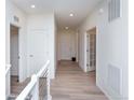 Bright and spacious hallway with light wood laminate flooring at 1837 Water Birch Way, Castle Rock, CO 80108