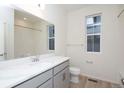 Modern bathroom with gray vanity, white countertop, and a shower/tub combo at 1837 Water Birch Way, Castle Rock, CO 80108