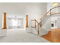 Grand entryway with hardwood floors and a curved staircase at 10199 Lodestone Way, Parker, CO 80134