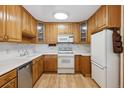 Bright kitchen with light wood cabinets and appliances at 660 S Alton Way # 5C, Denver, CO 80247