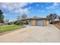 Front view of ranch home with driveway and yard at 7131 Clay St, Westminster, CO 80030
