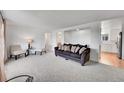 Living room with gray sofa and two accent chairs at 7131 Clay St, Westminster, CO 80030