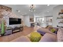 Open living room with stone accent wall, fireplace, and modern furniture at 3548 Corsica Way, Castle Rock, CO 80109