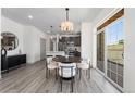 Modern dining area with kitchen access and patio view at 18633 Stroh Rd # 2-105, Parker, CO 80134