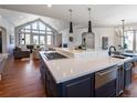 Modern kitchen with large island, stainless steel appliances, and hardwood floors at 385 Baxter Farm Ln, Erie, CO 80516