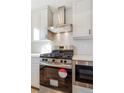 Stainless steel appliances and white penny tile backsplash in modern kitchen at 5870 W 91St Ave, Westminster, CO 80031
