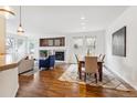 Bright dining area with hardwood floors and a wooden table, surrounded by beige chairs at 8490 W Quarles Dr, Littleton, CO 80128