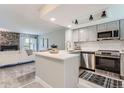 Open concept kitchen with white cabinets and a peninsula counter at 1649 S Ivory Cir # D, Aurora, CO 80017