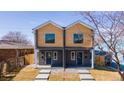 New construction duplex with gray siding, light wood accents, and modern design at 4341 N Columbine St, Denver, CO 80216