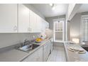 Efficient kitchen featuring white cabinetry and updated countertops at 325 E 18Th Ave # 206, Denver, CO 80203