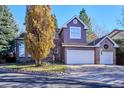 Two-story home with brick and siding exterior, two-car garage at 4756 E Pinewood Cir, Centennial, CO 80121