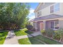 Two-story townhome with landscaping and walkway at 22580 E Ontario Dr # 103, Aurora, CO 80016