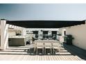 Spacious rooftop deck with hot tub, dining area, and grill, perfect for outdoor entertaining at 2556 18Th St, Denver, CO 80211