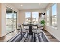 Bright dining area with sliding glass doors and a modern dining set at 6666 Bridle Creek Pt, Castle Pines, CO 80108