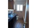 Bathroom with double vanity, a bathtub, and pink tile at 3306 S Uinta Ct, Denver, CO 80231
