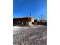 Backyard with a brick patio, gravel, and a small fenced area at 3306 S Uinta Ct, Denver, CO 80231
