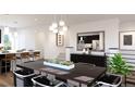 Elegant dining room with a large table and modern light fixtures at 3833 Whispering Sage St, Evergreen, CO 80439