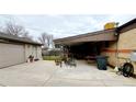 Large covered patio, adjacent to garage and provides shaded outdoor space at 7071 Zuni St, Denver, CO 80221