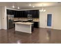 Modern kitchen with dark cabinets, granite island, and stainless steel appliances at 4630 Copeland Cir # 102, Highlands Ranch, CO 80126