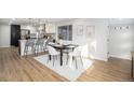 Modern dining area adjacent to updated kitchen at 6035 Everett St, Arvada, CO 80004