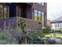 Close-up view of the house's brick facade and landscaping at 3362 W 32Nd Ave, Denver, CO 80211
