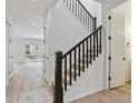 Modern staircase with dark wood railing and light walls at 8479 Cokedale Dr, Littleton, CO 80125