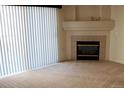 Living room with corner fireplace and neutral carpeting at 3220 Boulder Cir # 103, Broomfield, CO 80023