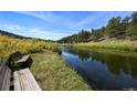Peaceful river view with benches, ideal for relaxation at 2677 S Platte River Rd, Sedalia, CO 80135