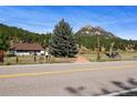 House exterior with mountain views and vintage truck at 2677 S Platte River Rd, Sedalia, CO 80135