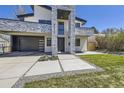 Modern home with stone and stucco exterior, two-car garage, and landscaped entry at 3212 S Dahlia St, Denver, CO 80222