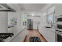 Modern kitchen with stainless steel appliances and island at 1458 S Fairfax St, Denver, CO 80222