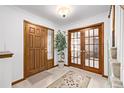 Bright entryway with wood floors, a coat closet, and French doors at 1324 Shadow Mountain Dr, Highlands Ranch, CO 80126
