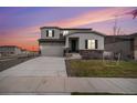 Two-story house with gray siding, attached garage, and landscaping at 18235 Caffey Dr, Parker, CO 80134