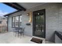 Inviting front porch with a small table and chairs, plus a new storm door at 1461 Utica St, Denver, CO 80204