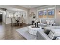 Open living and dining area with hardwood floors and view of kitchen at 2311 Decatur St, Denver, CO 80211