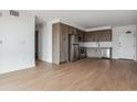Modern kitchen with stainless steel appliances and wood cabinetry at 3575 Chestnut Pl # 802, Denver, CO 80216