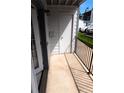 Private patio with storage unit and black railing at 13095 W Cedar Dr # 102, Lakewood, CO 80228